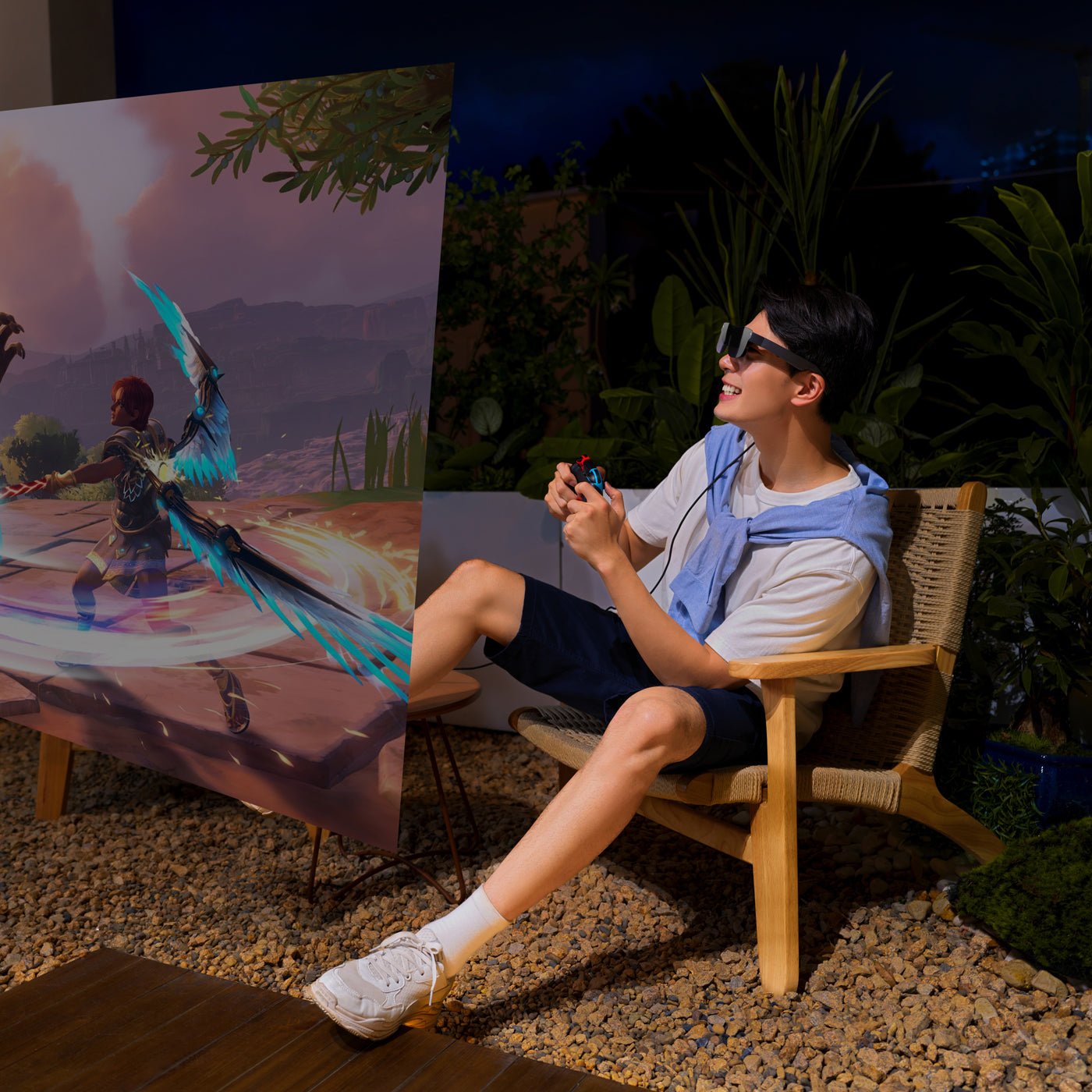 Man playing Nintendo Switch game outdoors using RayNeo best AR glasses on a large virtual screen.